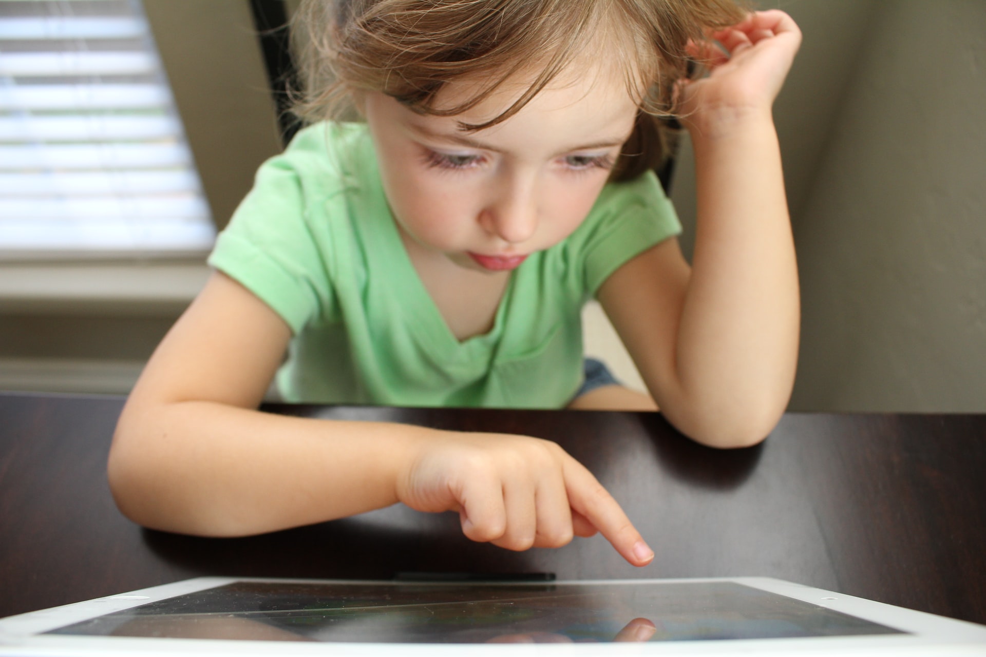 Young girl reading on a iPad